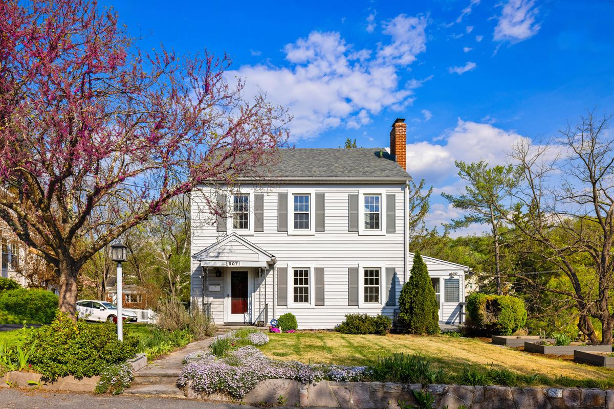 White home under a blooming redbud in evening light, Staunton