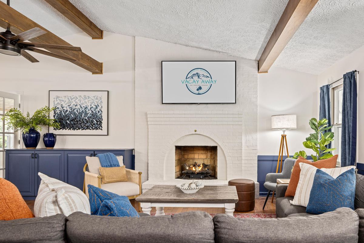 Great room with exposed beams in a river house